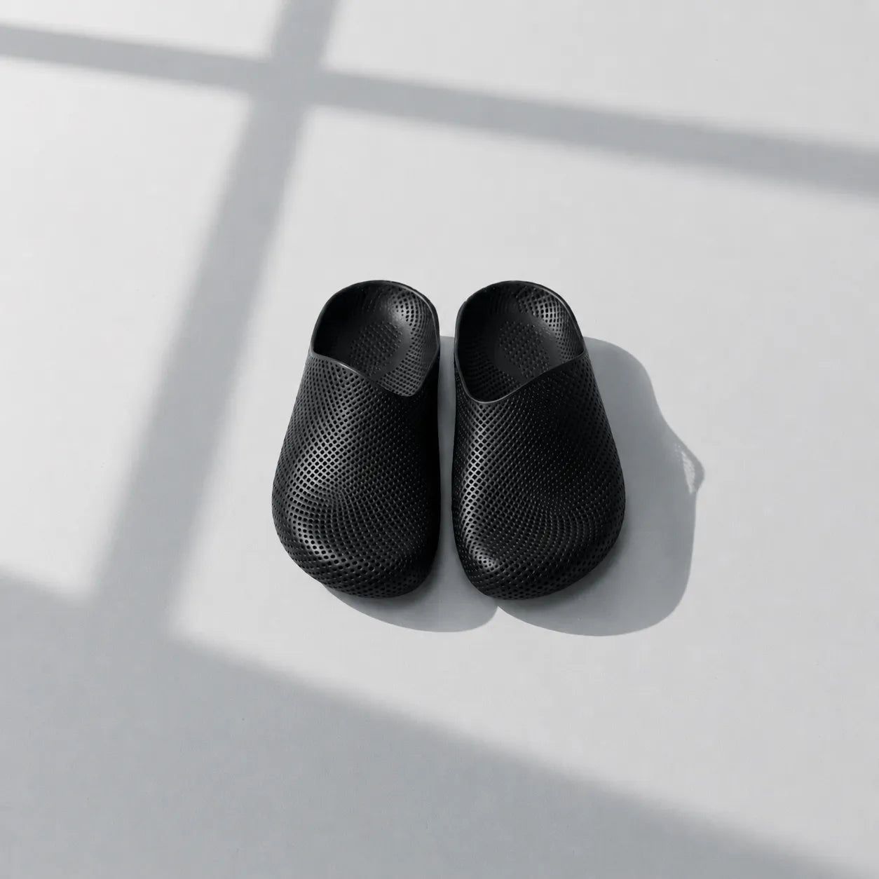 EASE 01 3D printed house slipper —  showing fine mesh lattice upper and minimal sole