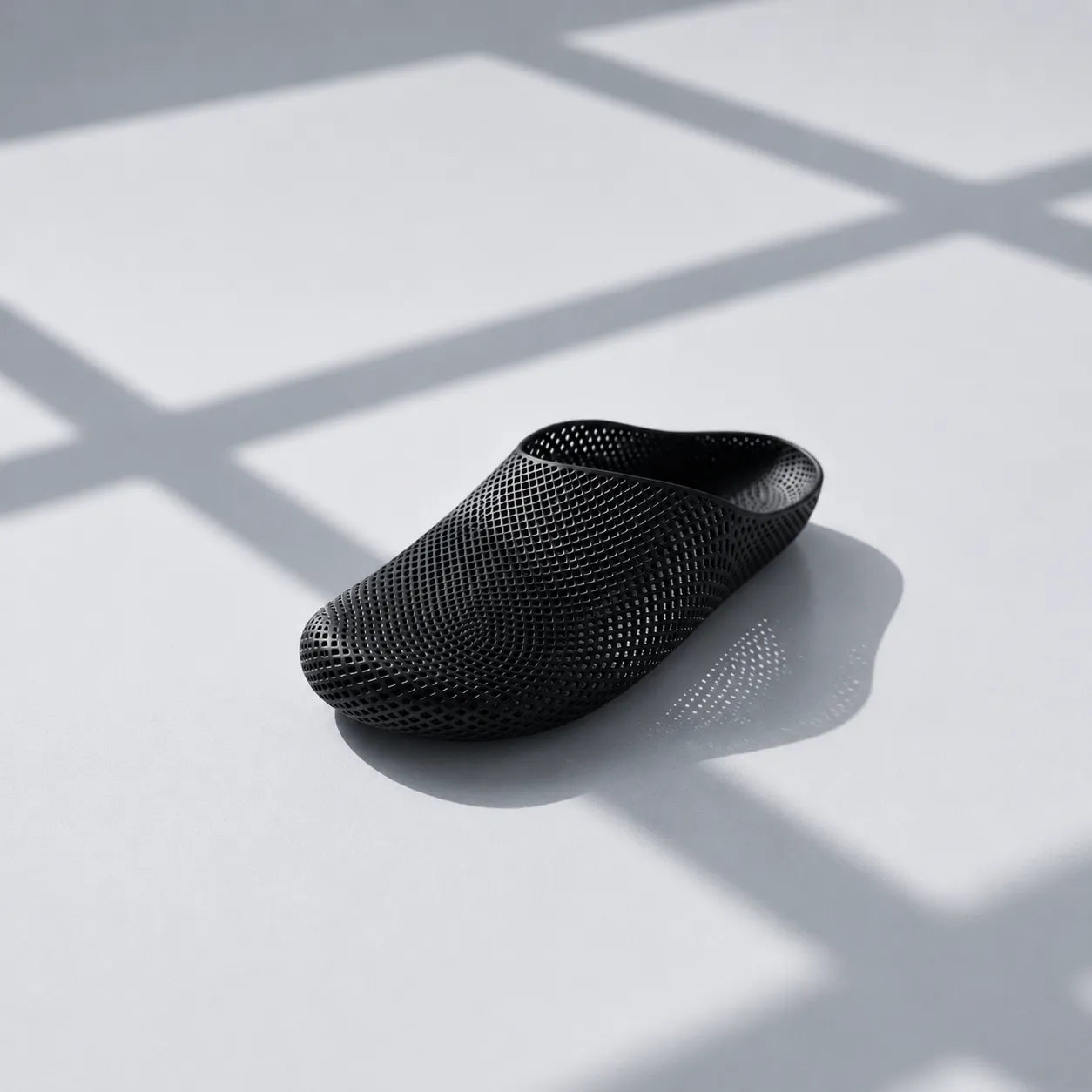 EASE 01 3D printed house slipper —  showing fine mesh lattice upper and minimal sole