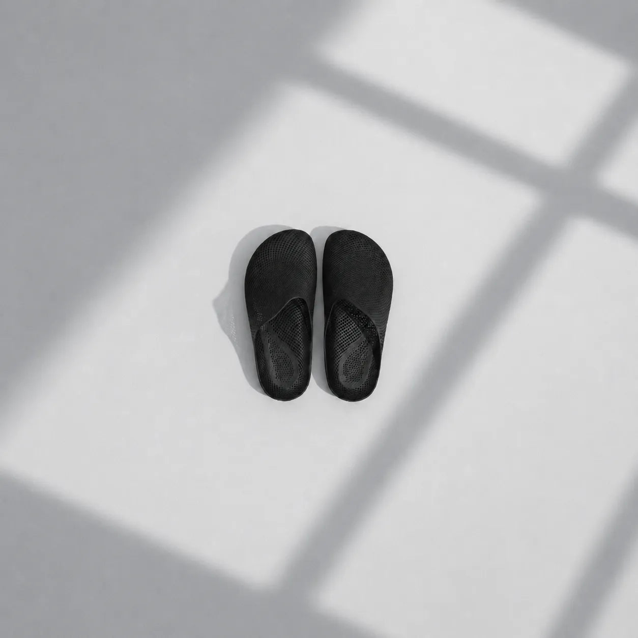 EASE 01 3D printed house slipper —  showing fine mesh lattice upper and minimal sole