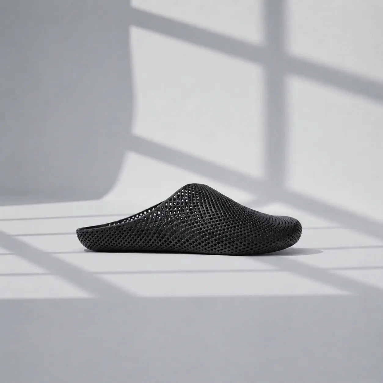 EASE 01 3D printed house slipper —  showing fine mesh lattice upper and minimal sole