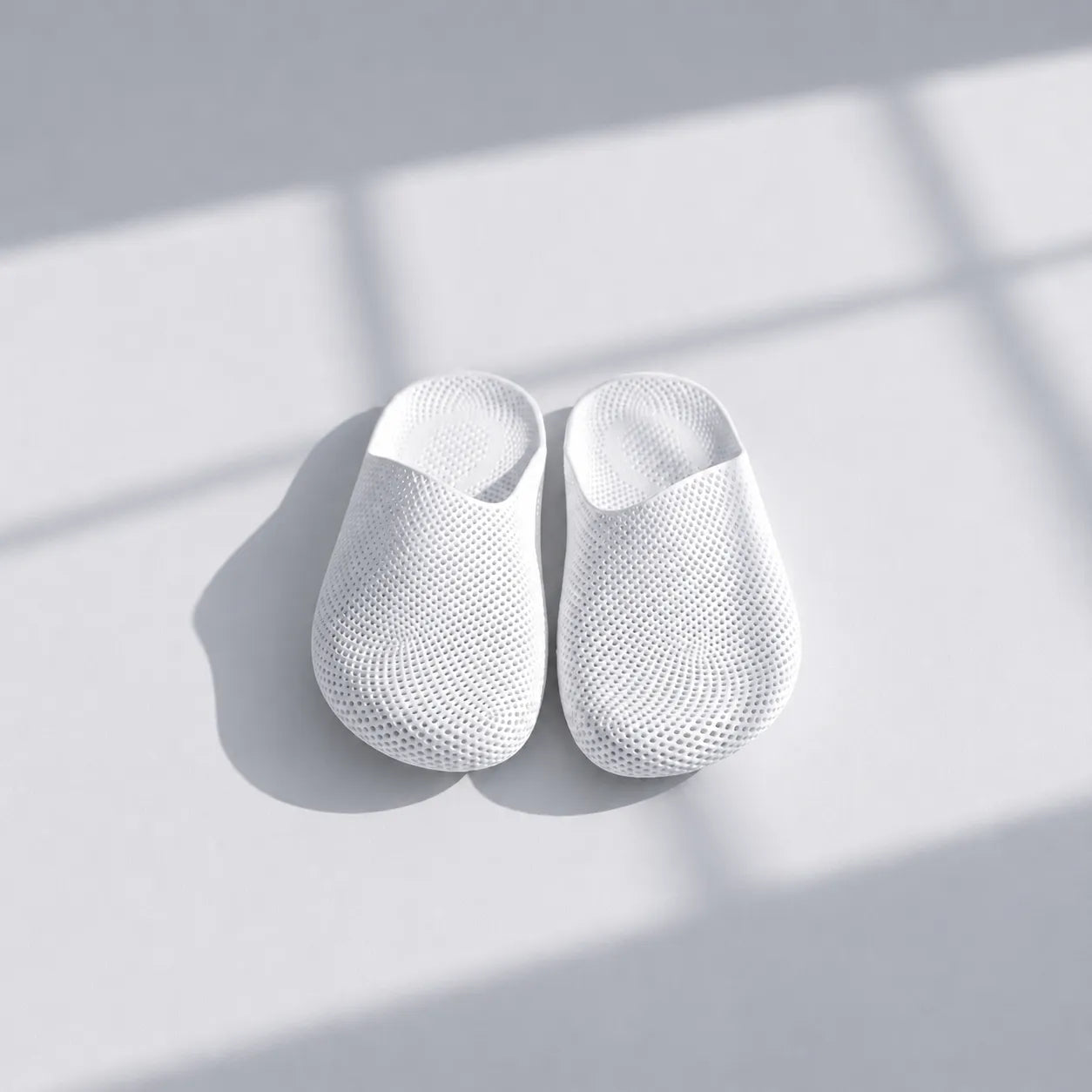 EASE 01 3D printed house slipper —  showing fine mesh lattice upper and minimal sole