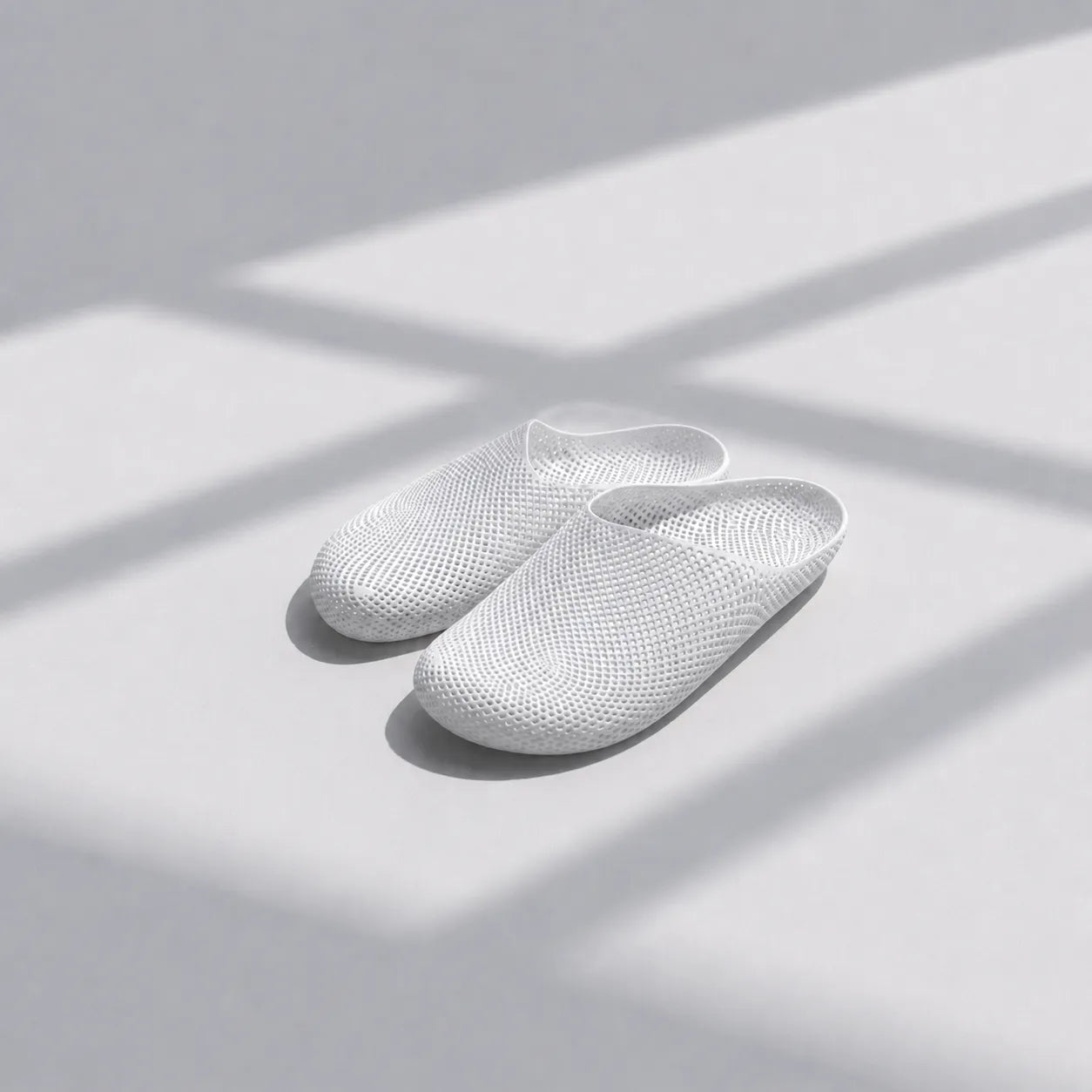 EASE 01 3D printed house slipper —  showing fine mesh lattice upper and minimal sole