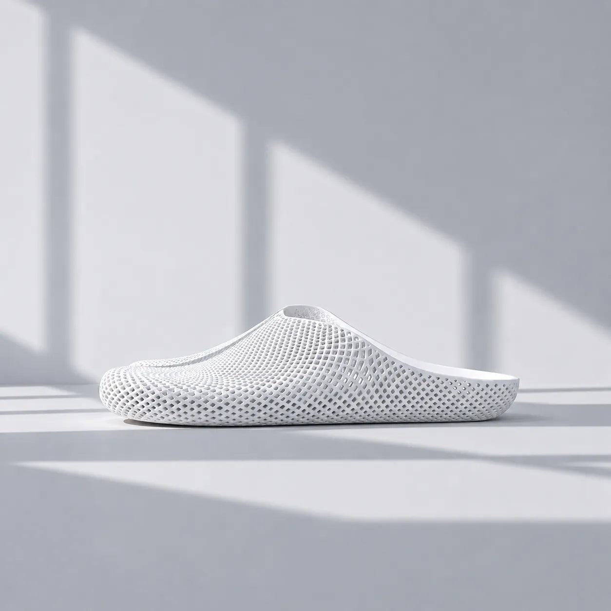 EASE 01 3D printed house slipper —  showing fine mesh lattice upper and minimal sole