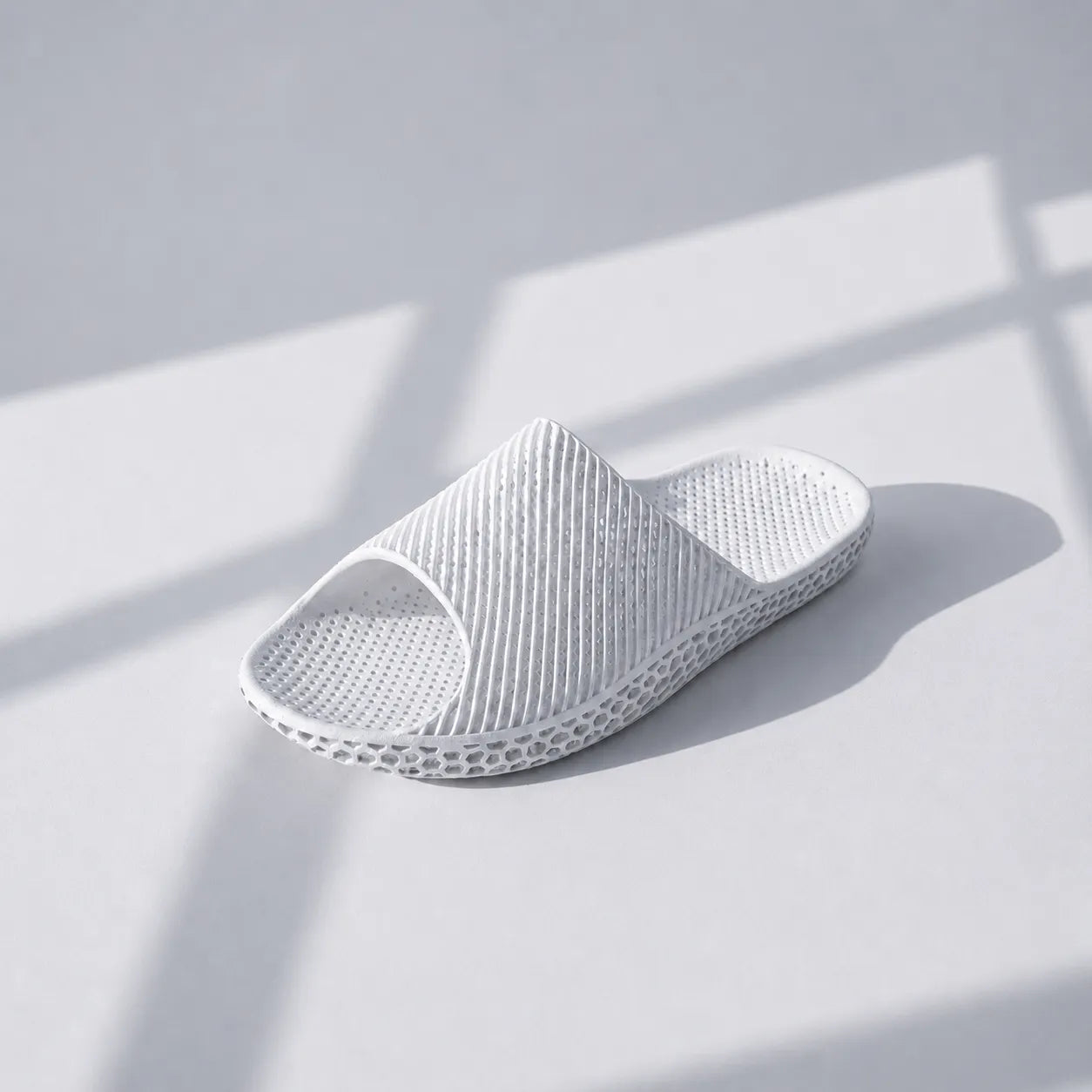 EASE 02 3D printed slide sandal — wave-textured upper and open honeycomb lattice sole